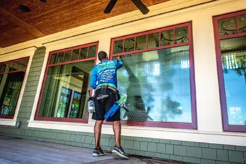 Pepper's technician cleaning exterior home windows with a water-fed pole in the Charleston, SC area