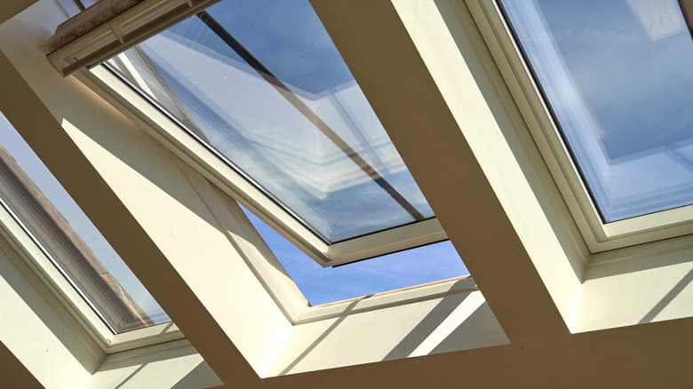 Clean skylights with crystal-clear glass and blue sky visible through the panes after Charleston, SC professional skylight cleaning