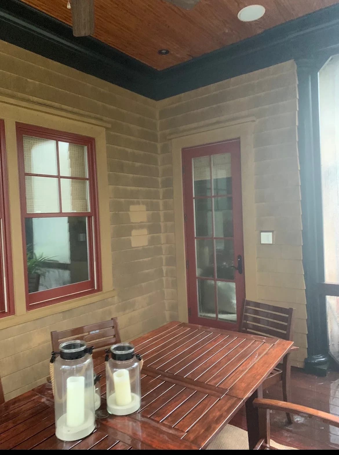 Porch windows hazy with pollen and grime before exterior window cleaning