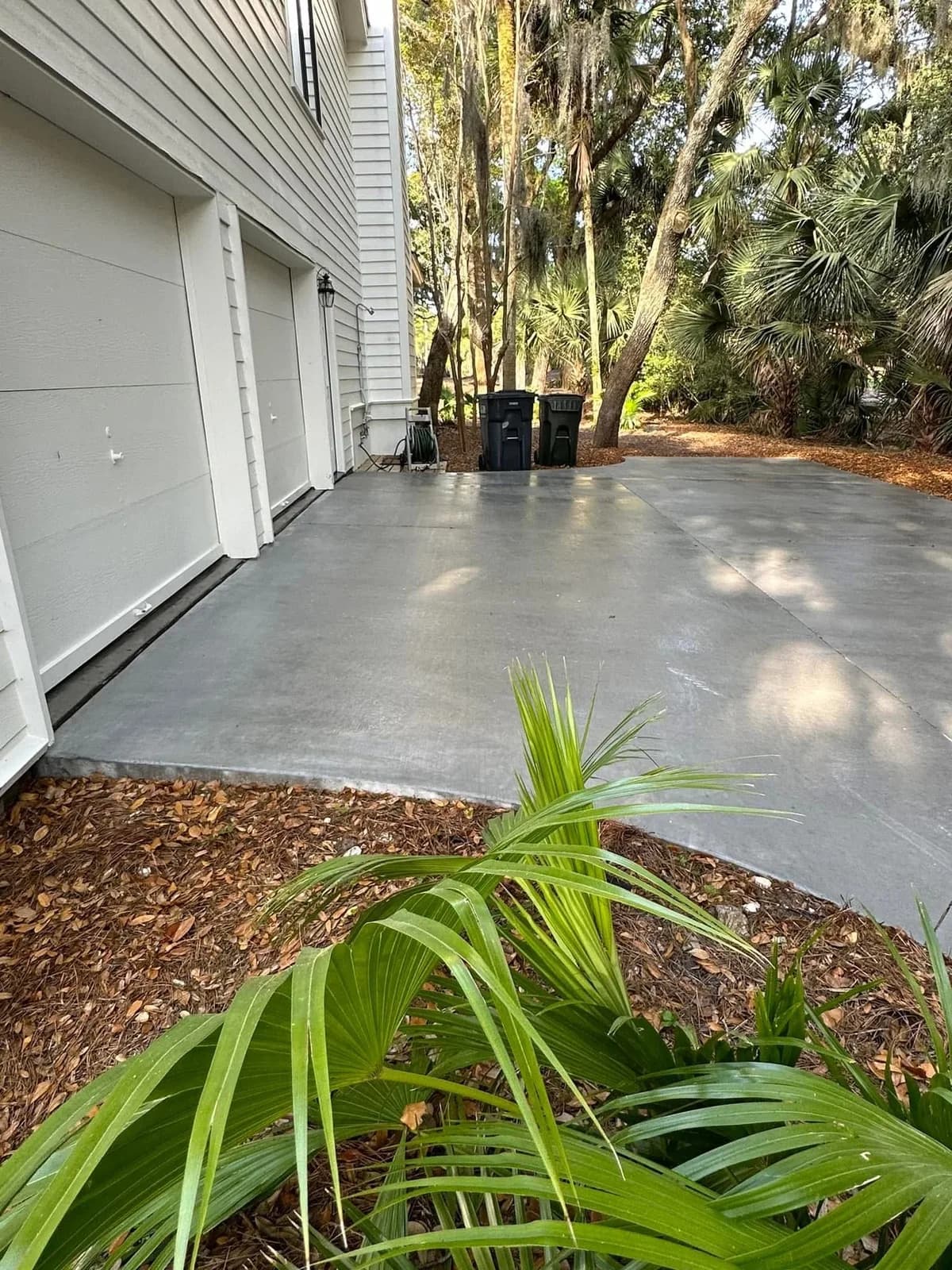 Concrete driveway and garage pad uniformly clean after pressure washing