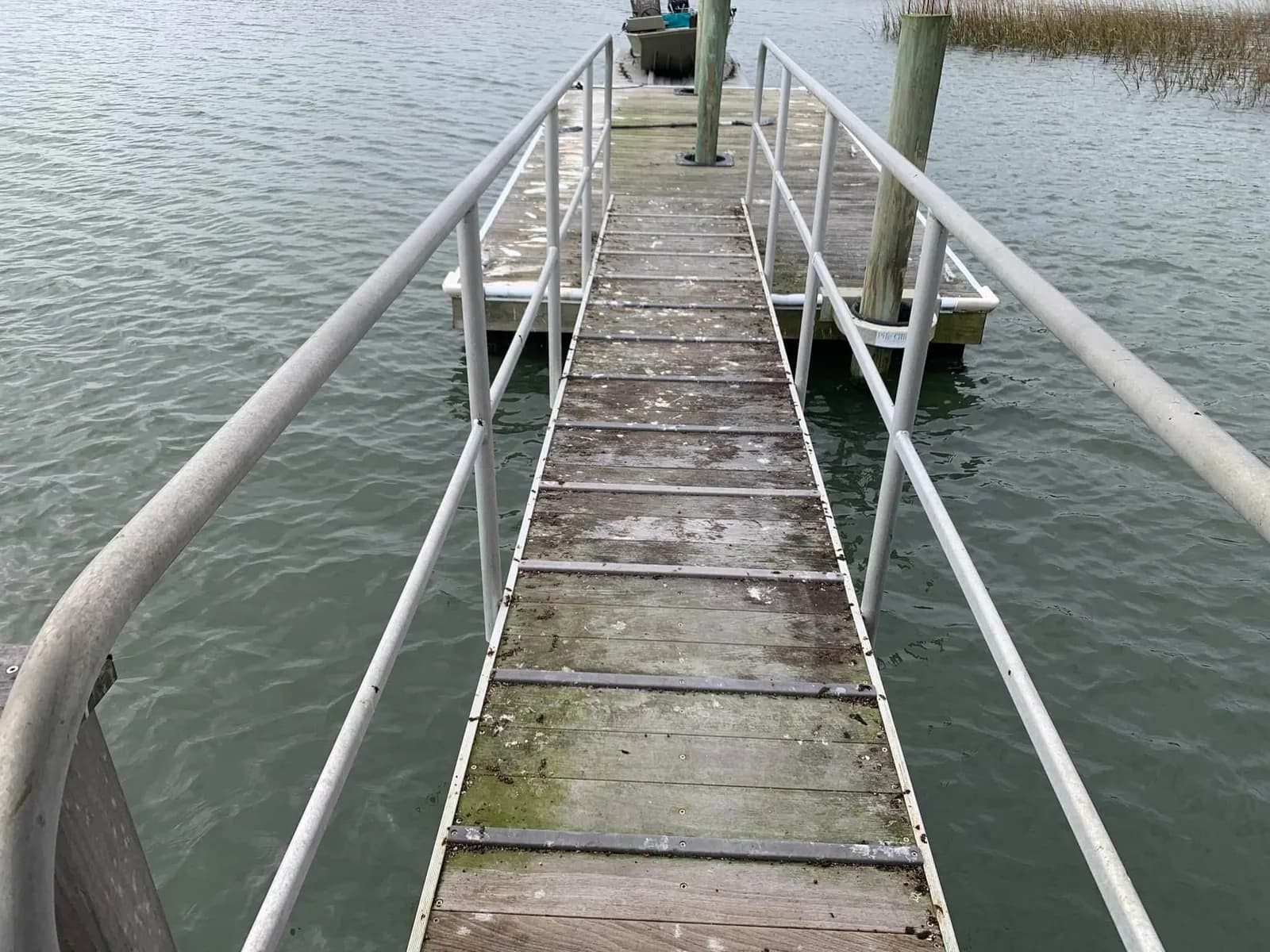 Kiawah Island private dock with algae growth and salt buildup before professional dock pressure washing by Pepper's Pressure Washing