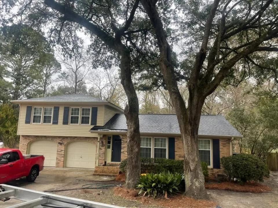 Charleston home vinyl siding with black mildew on north-facing wall before professional cleaning by Pepper's Pressure Washing