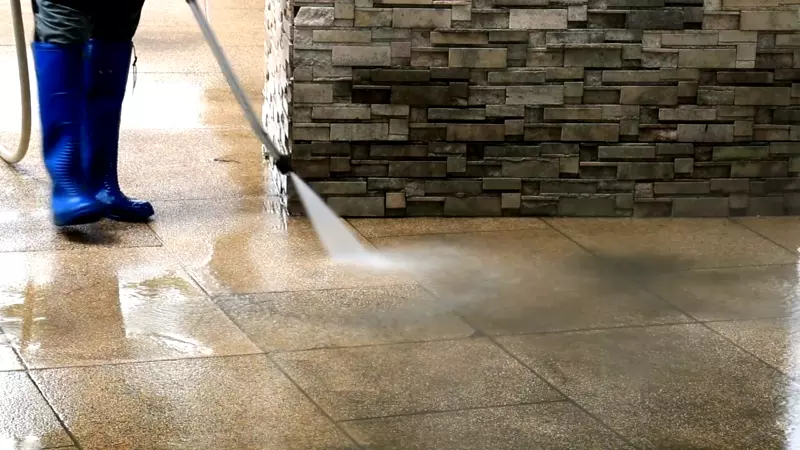 Pepper's Pressure Washing team cleaning a commercial storefront and sidewalk in Charleston