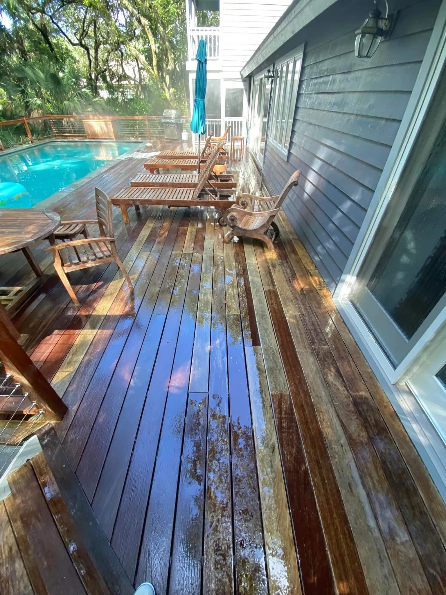 Restored chocolate-brown IPE pool deck with clean Brazilian walnut grain after professional cleaning and oxygenated brightener treatment by Pepper's Pressure Washing in Charleston, SC