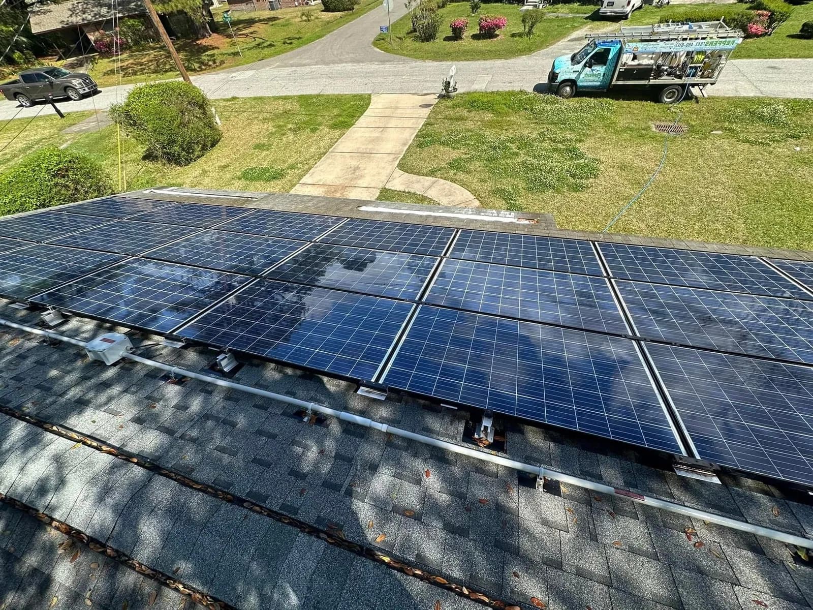 Pepper's Pressure Washing solar panel cleaning before-and-after on a Charleston rooftop array — pollen and salt-haze cleared with deionized soft wash